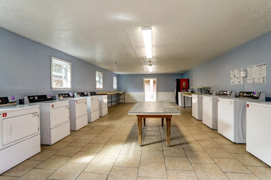 A laundromat with rows of washers and dryers.